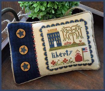 Cross stitch the famous american icon, the statue of liberty, on a background of clouds and sky. "Little Lady Liberty" | Cross Stitch Pattern