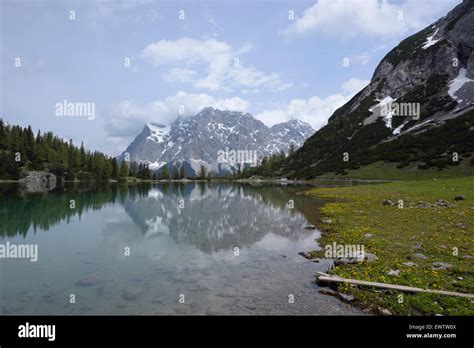 Zugspitze Massif Reflecting In Mountain Lake Seebensee Austria Stock