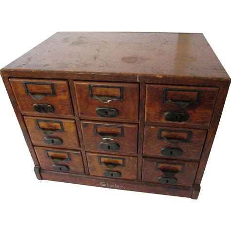 High quality card file cabinet made from wood and featuring over a dozen smaller drawers and a single large one at the top. Antique Globe 9 Drawer Index Card File Cabinet, patent ...