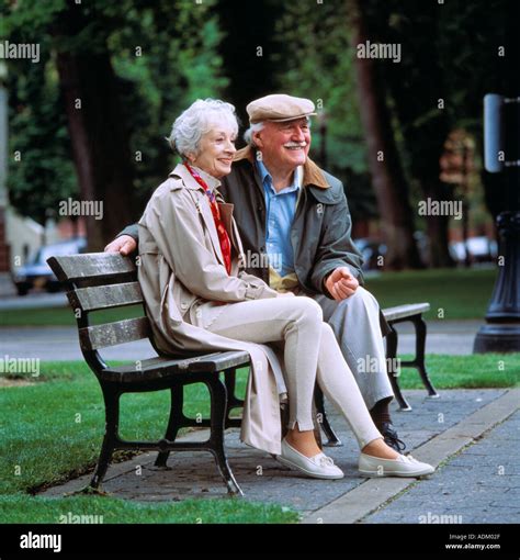 Old Couple Sitting On Park Bench Together Stock Photo Alamy