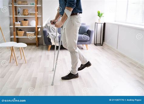Disabled Man Using Crutches To Walk Stock Photo Image Of Plant