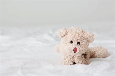 Premium Photo Teddy Bear Lying Down Relaxing On Bed