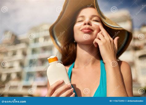 Suntan Lotion Woman Applying Sunscreen Solar Cream On Face Beautiful Happy Cute Girl Puts
