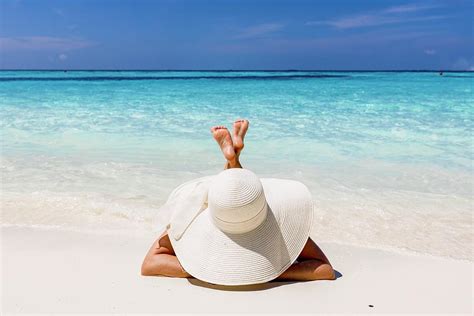 Woman With Sun Hat Sunbathing On The Beach Of Maldives Photograph By Kristian Sekulic Pixels