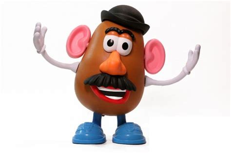 A Potato With A Hat And Mustache Is Posed In Front Of A White Background