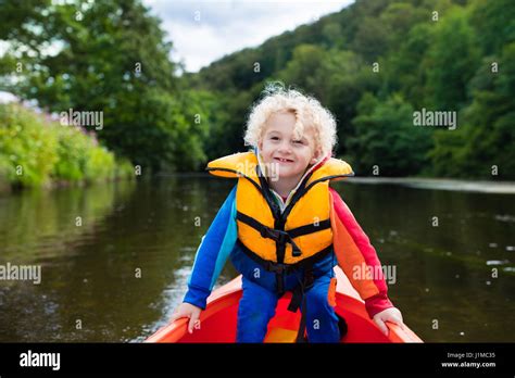 Happy Kid Enjoying Kayak Ride On Beautiful River Little Curly Toddler