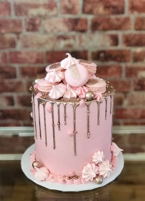 A Light Lemon And Coconut Cake Topped With Pink And Purple Meringues