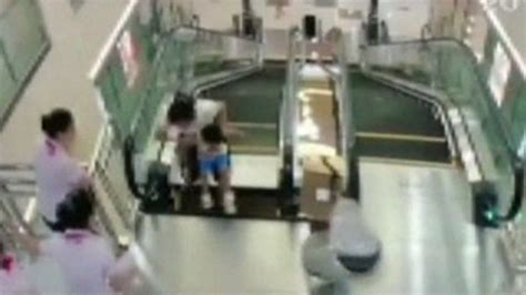 China Woman Dies After Falling Into Escalator Bbc News