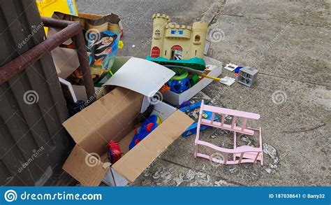 Broken Or Unwanted Childrens Toys Left Out By Recycling Bin For