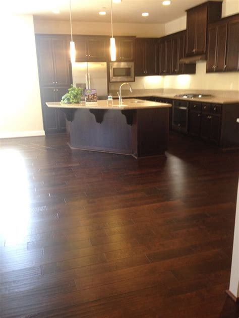 Browse inspirational photos of modern kitchens. Dark wood floor with dark cabinets