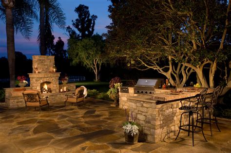 Rustic Stone Outdoor Kitchen And Fireplace Traditional