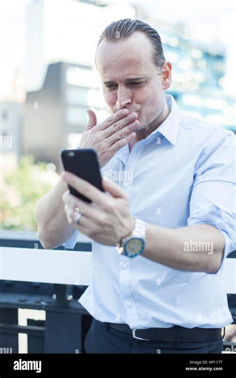 Man Blowing A Kiss At Smartphone Stock Photo Alamy