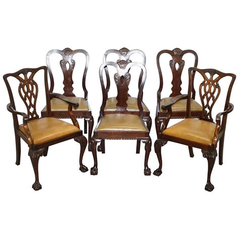 Glam dining room features an oval chippendale dining table lined with gray leather tufted dining chairs by baker atop a dark floor. Set of 6 Claw and Ball Mahogany Thomas Chippendale Style ...