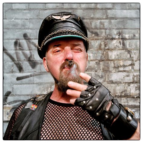 A Leather Daddy Smokes A Large Cigar While Posing For A Photo At