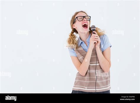 Geeky Hipster Woman Singing Into A Microphone Stock Photo Alamy