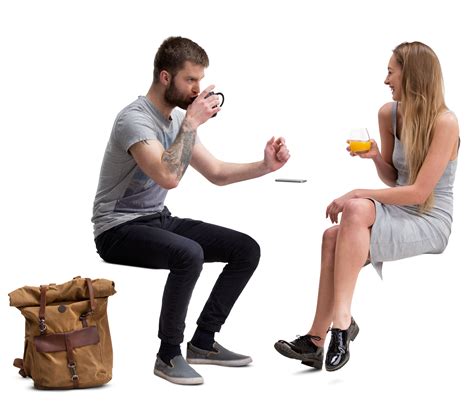 A Man And Woman Sitting Next To Each Other With Drinks In Their Hands Looking At Each Other