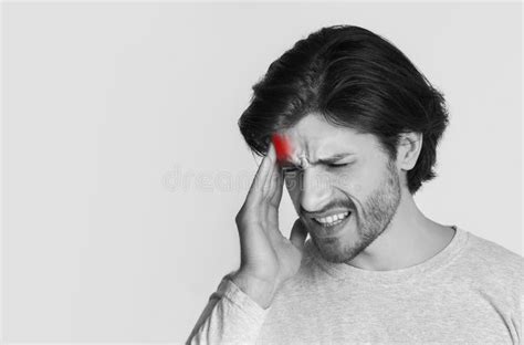 Headache And Throbbing Pain Portrait Of Man Massaging Temple Stock