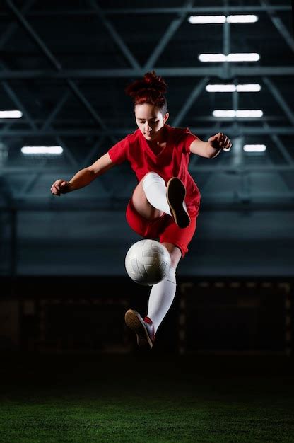 Free Photo Female Football Player Kicking Ball