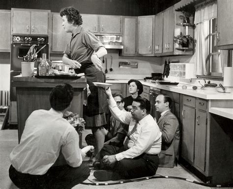 Image Of Julia Child Being Handed Plates And Food By Hidden People For