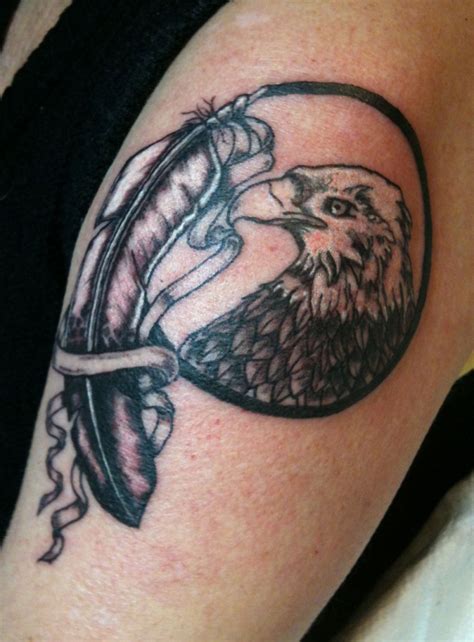 Cool Black And White Eagle Portrait And Ribboned Feather Tattoo On Arm
