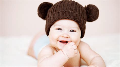 Cute Smiley Baby Is Wearing Brown Knitted Woolen Cap