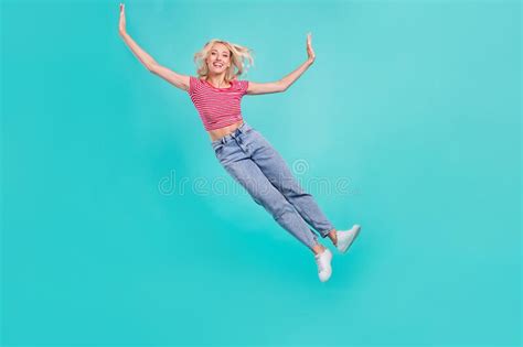 Photo Of Charming Funky Young Lady Wear Striped T Shirt Jumping High