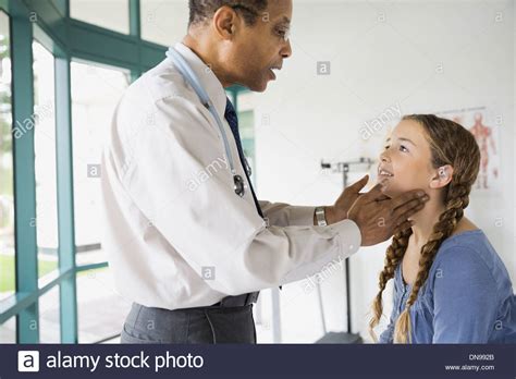 Doctor Examining Girl At Checkup Stock Photo Alamy
