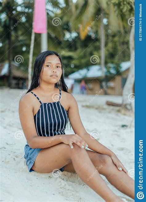 Portrait Of A Beauitful Brown Skin Filipina Model On A White Sand Beach In The Philippines Stock