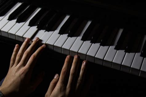 Premium Photo Two Male Hands On The Piano Palms Lie On The Keys And