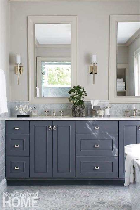Bad lighting, lack of storage, and constantly fogged up surfaces! Master bathroom with dark gray vanity, light gray floors ...