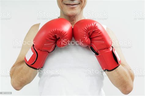 Portrait Of Asian Senior Fighter Man With Red Boxing Gloves On White