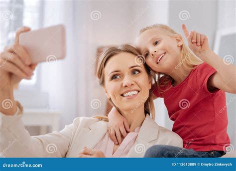 happy positive mother and daughter taking a selfie stock image image of home generation
