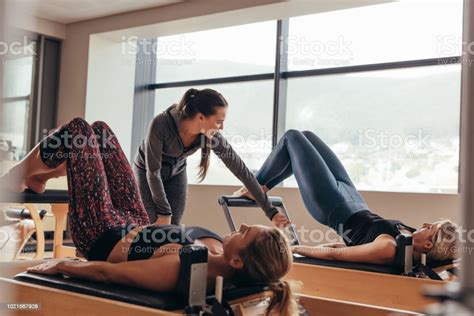 Pilates Trainer Instructing Women At The Gym Stock Photo Download