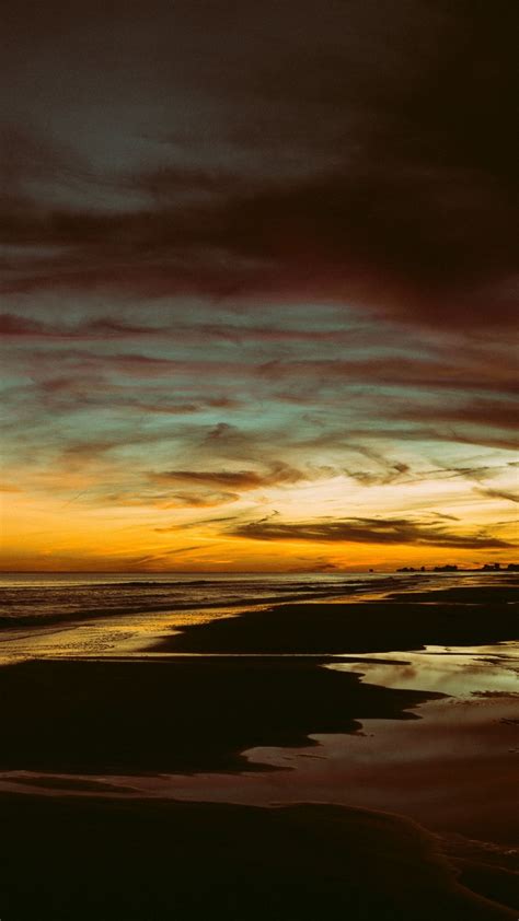 Beautiful Ocean Beach Sand Under Yellow Black Clouds Sky Silhouette