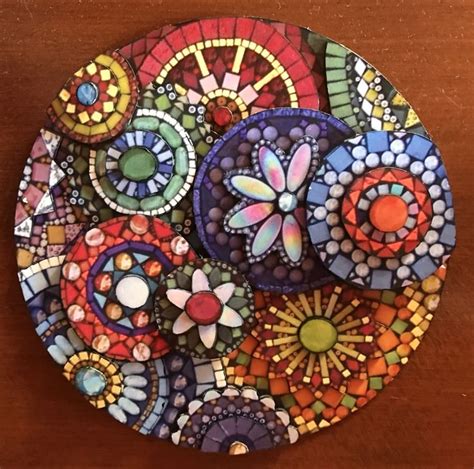 A Colorful Plate With Many Different Designs On The Top And Bottom Sitting On A Wooden Table