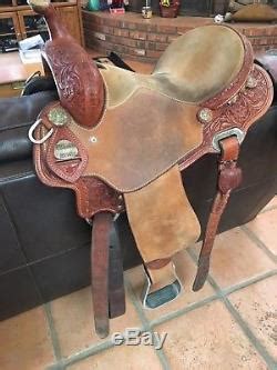 The record breaker barrel saddle is handmade in texas and has roughout seat jockeys and fenders, leg cutout in the skirt, and rubber grip aluminum. 14 Charmayne James Record Breaker Barrel Saddle
