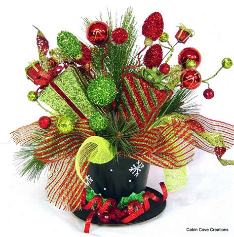 They add a sense of hope and joy to our lives, and it would be hard to imagine what our world would be like without them. Top Hat Centerpiece Floral Arrangement Christmas Holiday red