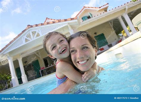Mother And Daughter Playing In Swimming Pool Stock Image Image Of