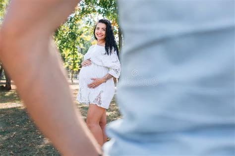 Pregnant Girl Walks In The Park With Her Husband Enjoy The Beautiful Weather Stock Image