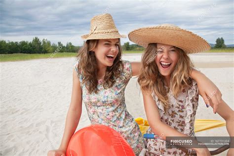 Smiling Women Having Fun On The Beach Portrait To Years Stock Photo