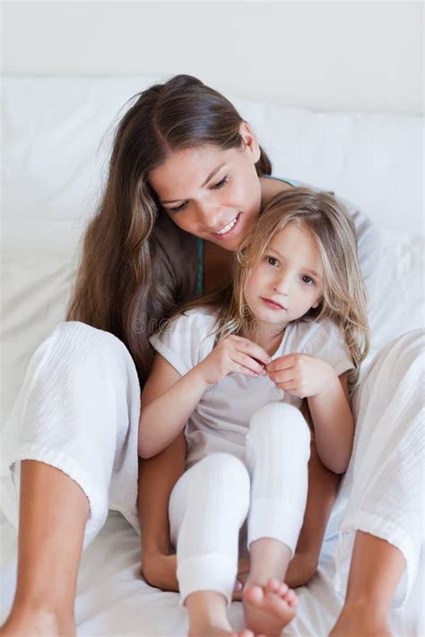 portrait of a mother and her daughter posing on a bed stock image image of motherhood mother