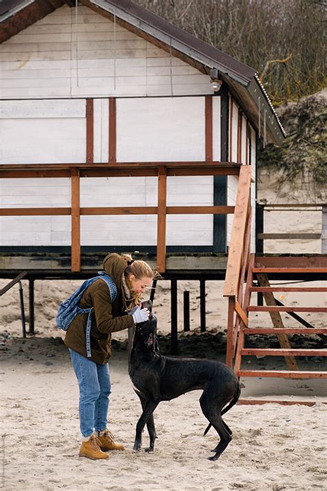 Woman Petting Her Dog Friend By Stocksy Contributor Danil Nevsky