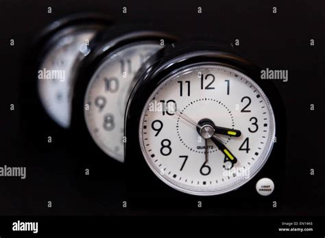 Three Alarm Clocks One Behind The Other Second Hand Showing Movement