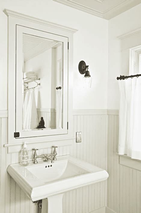 Nature oriented theme runs in this bathroom, featuring tree wallpaper, wood beadboard, wood ceiling, mirrors with twigs style frame and the earthy wall sconces. Beadboard Bathroom Design Ideas