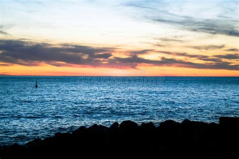 Seascape Silhouette And Firing Sky At Horizon During Sunset Stock Image