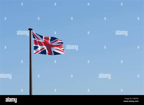 Union Jack Flag Flying Against A Blue Sky Stock Photo Alamy