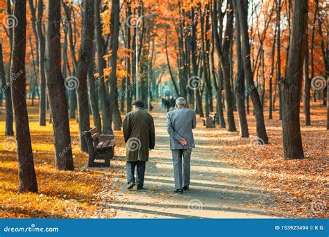 Two Senior Friends Man Walking Along Beautiful Colorful Autumn City