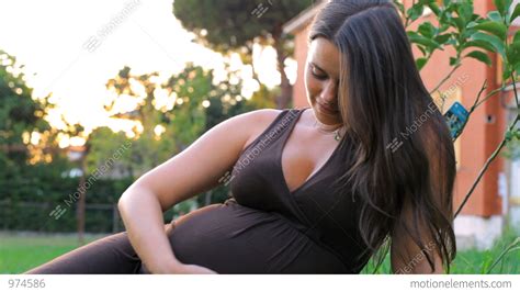 Closeup Of Woman Touching Her Pregnant Belly Stock Video Footage 974586