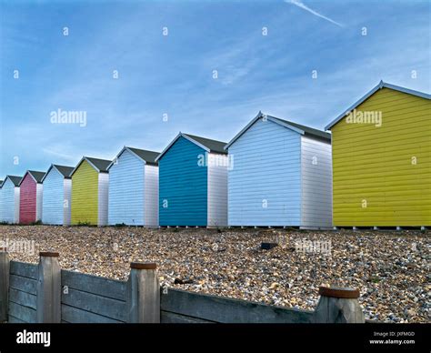 Row Of Brightly Painted Colourful Wooden Beach Huts On Eastbourne