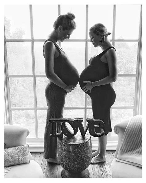Two Pregnant Women Standing Next To Each Other With The Word Love Spelled In Front Of Them
